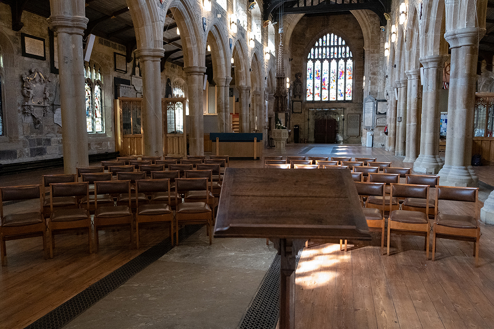Bradford Cathedral nave with curved seating and a lectern.
