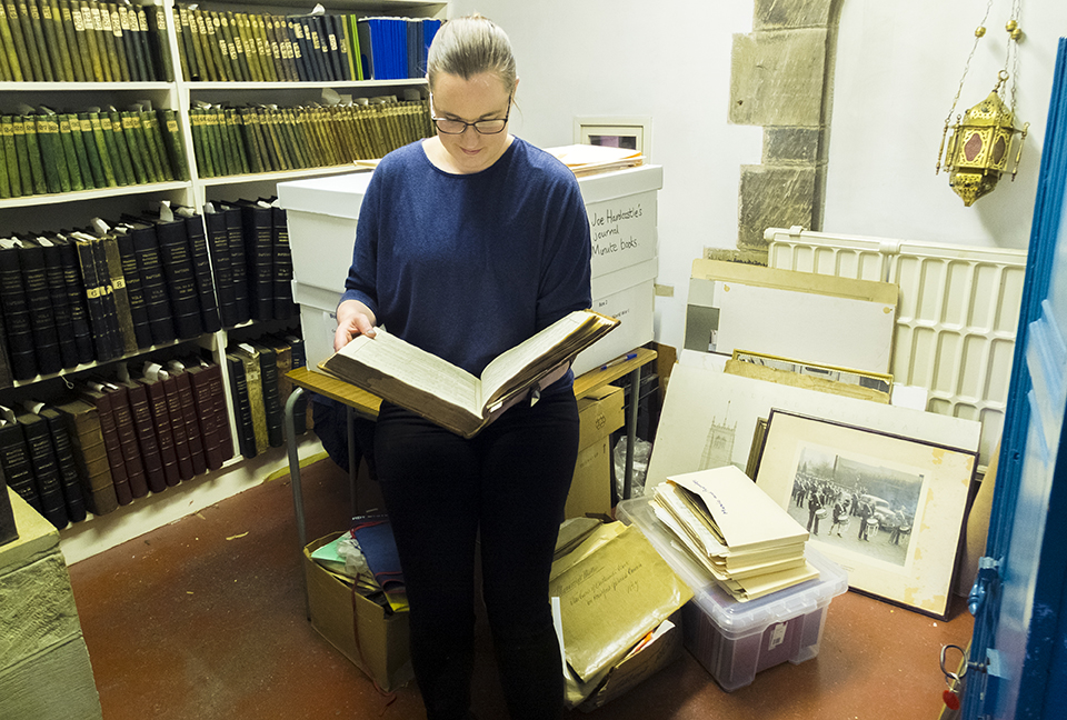 Fiona Marshall from the West Yorkshire Archive Service looking through some of the items in the Bradford Cathedral archive.