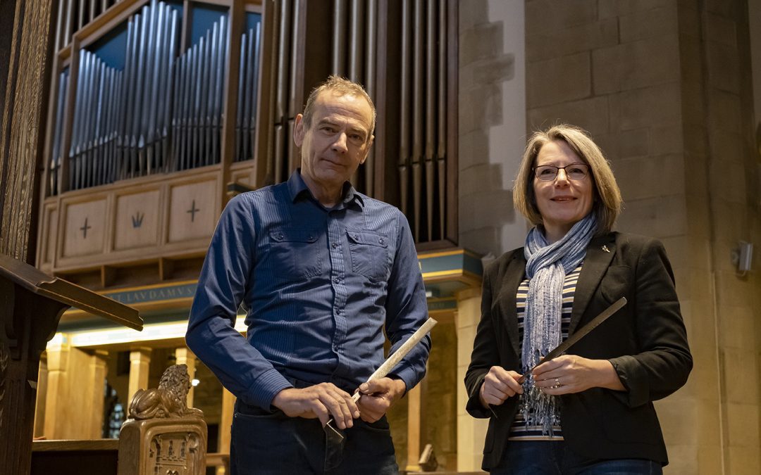 Mark and Ginny from organ builders Peter Wood and Son Organ Builders Limited, standing next to the Bradford Cathedral organ.