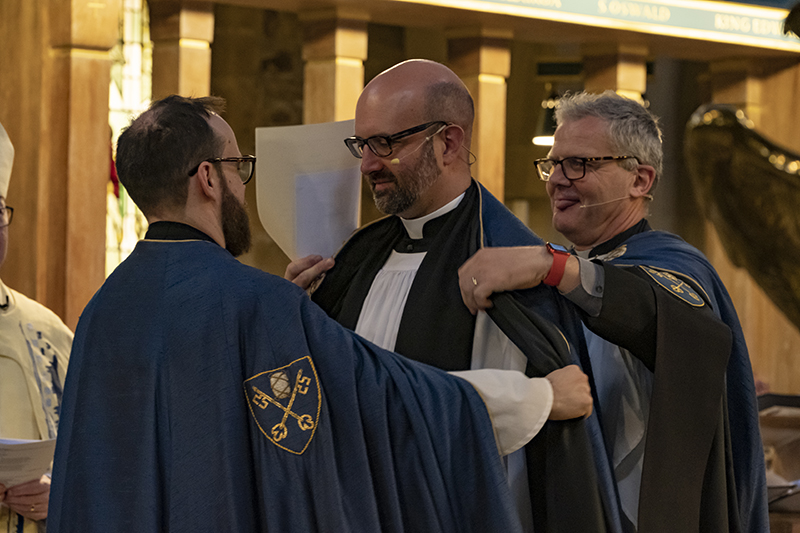 The Revd Pete Gunstone receives the cope, a garment of office